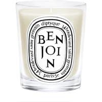 Diptyque Benjoin candle in clear glass holder with black and white label featuring bold text.