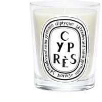 Clear glass jar with white wax, labeled "Cypres" in black text, by Diptyque, featuring a woody scent.