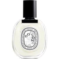 Clear glass bottle of Diptyque Do Son Eau de Toilette, black cap, oval label with floral design.