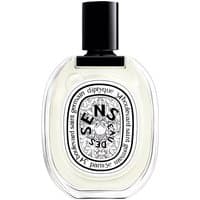 Clear oval bottle of Diptyque Eau des Sens Eau de Toilette with black cap and intricate label design.