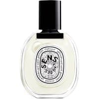 Clear oval bottle of Diptyque Eau des Sens Eau de Toilette, black cap, intricate label design, 50 ml unisex floral perfume.