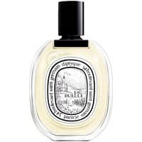 Clear glass bottle with black cap, oval label featuring intricate design, "Eau Duelle" text, unisex spicy perfume.
