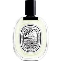 Clear oval bottle with black cap, featuring Diptyque label and "Eau Moheli" text, containing light yellow unisex floral perfume.