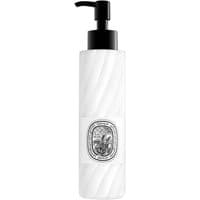 White Diptyque Eau Rose lotion bottle with black pump and ornate oval label.