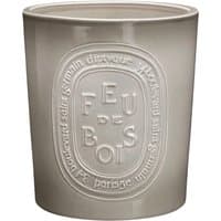 Beige Diptyque Feu De Bois candle in a large ceramic holder with embossed logo and text.