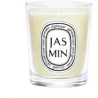 Clear glass jar with white Diptyque Jasmin candle, black oval label with text, and creamy wax inside.