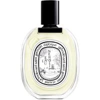 Clear glass bottle of Diptyque L'Eau de Neroli Eau de Toilette with black cap and ornate white label.