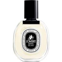 Clear glass bottle of Diptyque L'Ombre dans l'Eau perfume with black cap and oval label.