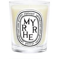 Diptyque Myrrhe candle in clear glass holder with black and white label, featuring bold text and decorative border.