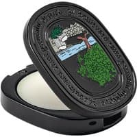 Black oval compact with embossed design, containing Diptyque Philosykos solid perfume, 3g, featuring a scenic illustration.