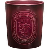 Dark red Diptyque Tubereuse candle, 1500 g, with embossed oval label and floral scent.