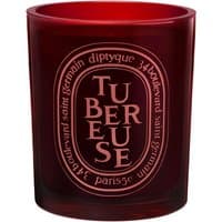 Red glass Diptyque Tubereuse candle with oval label and white text, 300 g floral scent.