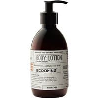 Dark amber bottle of Ecooking Body Lotion with black pump and white label detailing ingredients.