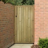 Wooden garden gate, 3' x 6', vertical tongue and groove, pressure treated, set between red brick walls.