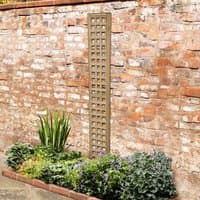 Forest Garden trellis, 6' x 1', premium framed, square lattice design, wooden, against brick wall, above flower bed.