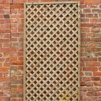 Wooden diamond trellis, 6' x 1', pressure treated, with a lattice pattern, leaning against a brick wall.