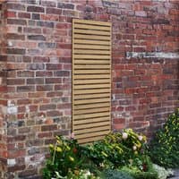 Wooden slatted trellis panel, 6' x 2', pressure treated, mounted on a brick wall, surrounded by garden plants.