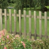 Forest Garden 6' x 3' pressure-treated pale picket fence panel with vertical slats and rounded tops in a garden setting.