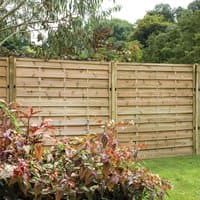 Wooden decorative fence panel with horizontal slats, pressure-treated, 6' x 5', set in a garden with greenery.
