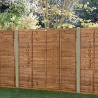 Brown pressure-treated wooden fence panel with horizontal slats, 6' x 5'6, set in a garden with trees.