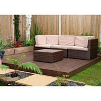 Brown composite decking kit, 8' x 8', with wood grain texture, set in a garden with a wicker sofa and plants.