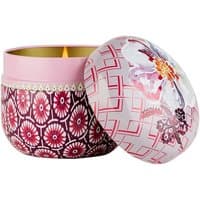 Pink and red patterned Fragonard candle with floral lid, featuring a spicy scent of ginger and vetiver.