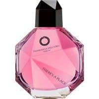 Pink geometric bottle of Francesca dell'Oro There's a Place Eau de Parfum with black cap.