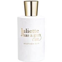 White cylindrical bottle of "Juliette has a Gun - Another Oud" perfume with gold cap and lettering.