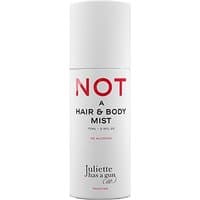 White cylindrical bottle of Juliette has a Gun Not a Hair and Body Mist with bold red and black text.