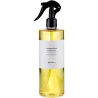 Clear bottle of Laboratorio Olfattivo Agrumeto Citrus Room Spray, 500 ml, with black spray nozzle and white label.
