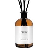 Amber glass diffuser bottle with black reeds and white label, "Laboratorio Olfattivo - Distillato 17 Woody Diffuser."