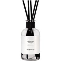 Clear glass bottle with black reeds, white label reading "Laboratorio Olfattivo - MeloMirtillo," fruity diffuser.