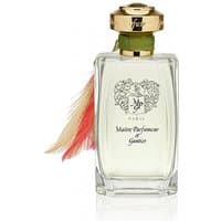 Clear glass bottle with gold cap, green ribbon, and feather detail, labeled "Maitre Parfumeur et Gantier Bahiana Eau de Parfum."