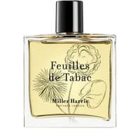 Clear glass bottle of Miller Harris Feuilles De Tabac Eau de Parfum, black cap, floral design on label, 100 ml.