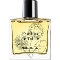 Clear glass bottle of Miller Harris Feuilles De Tabac perfume with black cap and botanical illustration.