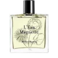 Clear glass bottle of Miller Harris L'Eau Magnetic Eau de Parfum, black cap, floral design on label, 100 ml.
