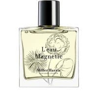 Clear glass bottle of Miller Harris L'Eau Magnetic Eau de Parfum, featuring floral design and black cap, 50 ml.
