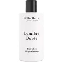 White Miller Harris Lumiere Doree body lotion bottle with black cap, 250 ml, featuring elegant black text.