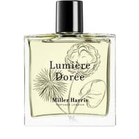 Clear glass bottle of Miller Harris Lumiere Doree perfume with black cap and floral design on label.