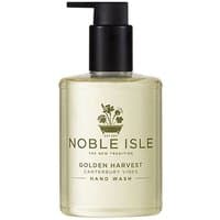 Clear bottle of Noble Isle Golden Harvest Hand Wash with black pump dispenser and green label.