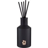Black Noble Isle diffuser with gold emblem, featuring sleek black reeds.