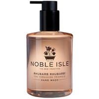 Clear bottle of Noble Isle Rhubarb Rhubarb! Hand Wash with black pump and floral label design.
