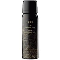 Black Oribe dry texturizing spray bottle with gold text and abstract design, purse travel size for all hair types.