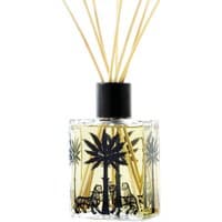 Ortigia Ambra Nera diffuser with palm tree design, black cap, and reed sticks in a clear square glass bottle.