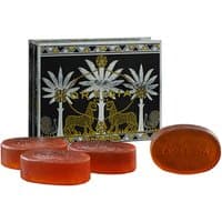 Ortigia Ambra Nera glycerine soap kit, four amber oval bars, ornate black and gold box with palm tree design.