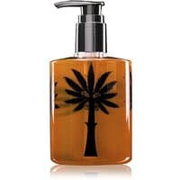 Amber Ortigia Zagara liquid soap bottle with black palm tree design and silver pump dispenser.