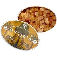 Ortigia Zagara scented crystals in an oval tin with palm tree design and amber-colored crystals inside.