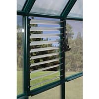 Green-framed louvre window opener with adjustable slats in a greenhouse setting.