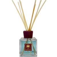 Square glass bottle with red cap, filled with blue liquid, featuring bamboo reeds; "Profumo di Campiglio" label.