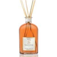 Clear glass bottle of Salentum Agrumi diffuser with orange liquid and reed sticks.